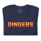 Close up image of navy t-shirt with design of "DINGERS" in Houston Astros tequila sunrise style font located on centre chest. This design is exclusive to Tailgate Mercantile and available only online.