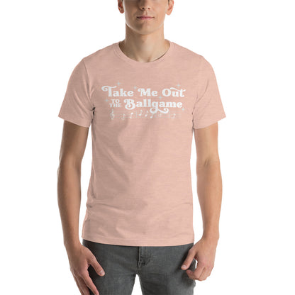Image of man wearing heather peach t-shirt with design of "Take Me Out to the Ballgame" with coordinating musical notes in white located on centre chest. This design is exclusive to Tailgate Mercantile and available only online.