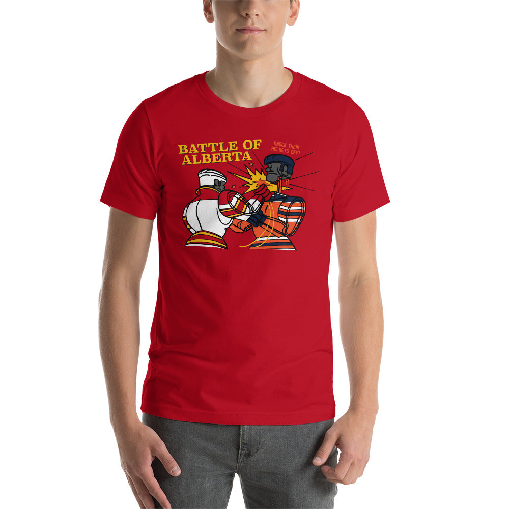 Image of young man wearing red t-shirt with design of "Battle of Alberta" with rock'em, sock'em style hockey players fighting located on centre chest. Players in the design are completed in NHL Calgary Flames and Edmonton Oilers colours. This design is exclusive to Tailgate Mercantile and available only online.